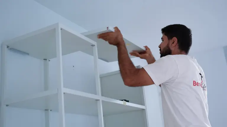 Möbelmontage: Benoha-Mitarbeiter baut ein Regal auf